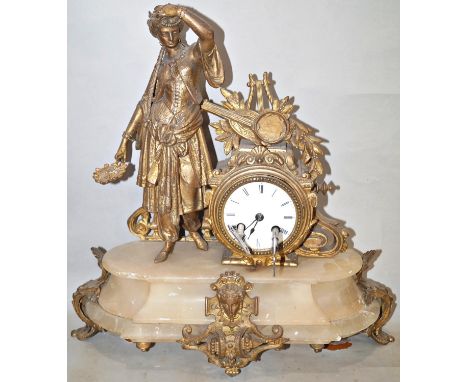 A mid-19th century onyx mantle clock, the brass case work enclosing an eight day striking movement with enamelled dial, surmo