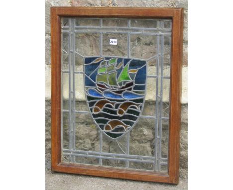 An Arts &amp; Crafts style leaded light panel with shield shaped galleon and fish detail within a good quality bespoke throug