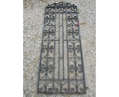A heavy gauge painted iron pedestrian side gate with repeating open scroll work panels, 80 cm wide x 196 cm high 