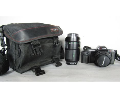 Photographic equipment including an Olympus OM 707 camera and an Olympus zoom lens in a grey Tek bag.