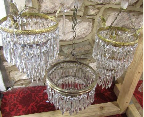 Two Edwardian style three tier crystal bag chandeliers, one smaller than the other and a single larger three tier Edwardian s