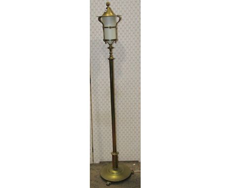 A brass lamp standard in the form of a street lantern, raised on a disk base with domed cap and adjustable column 