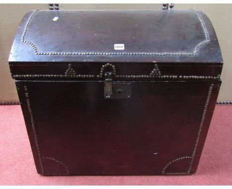 A 19th century pine trunk with domed lid and original stained finish with applied brass studwork detail, brass carrying handl
