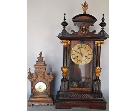 A late 19th century German mantle clock, the case with column supports and further decorated finish, enclosing an eight day s