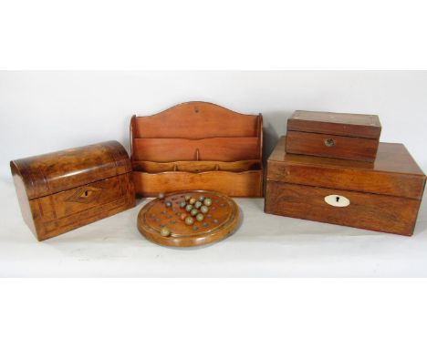 A mahogany letter rack, a walnut domed topped tea caddy, two further boxes and a solitaire board and some wooden balls. 