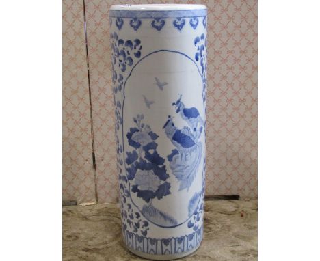 A Chinese ceramic stick stand in a blue and white colourway with birds and foliate detail 