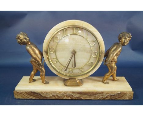 A mid 20th century onyx mantle clock, the casework supported by two gilded cherubs 