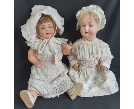 2 early 20th century German bisque head dolls, one by Schützmeister &amp; Quendt with 5 piece bent limb composition body, blu