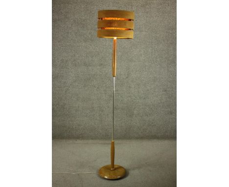 A circa 1970s walnut standard lamp, with a double walled cylindrical shade of three tiers. H.171cm. 