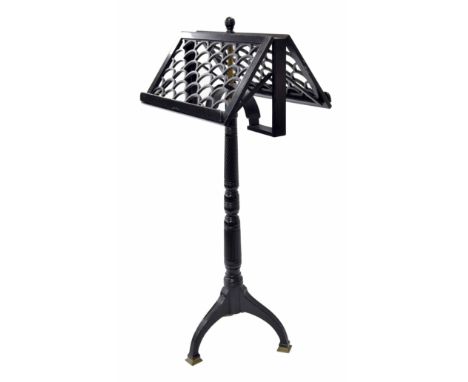 English ebonised adjustable duet music stand, the twin fish scale pierced ledges supported upon a wrythen and straight fluted