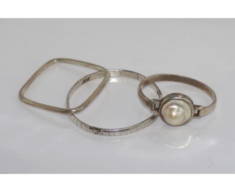Three various silver bangles one with Mabe pearl