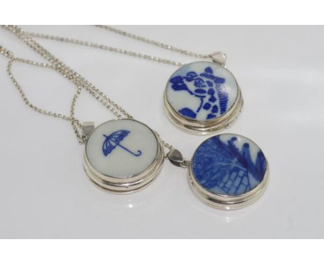 Three silver & ceramic lockets on silver chains