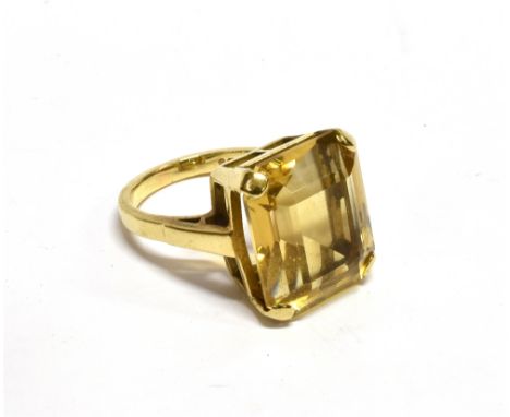 A 9CT GOLD AND RECTANGULAR CITRINE SINGLE STONE RING  the step-cut stone approx. 16mm x 13.9mm, in a four-claw setting on an 