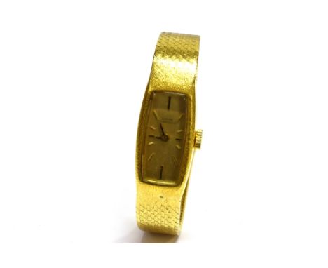 GIRARD PERREGAUX, A LADY'S SWISS 18K WATCH, ON AN INTEGRAL BRACELET STAMPED '14K' the satinised-golden tonneau-shaped dial wi
