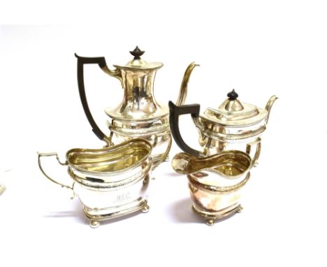 A SILVER OBLONG FOUR PIECE TEA AND COFFEE SERVICE,  with angular scroll handles, gadrooned borders and bands, a central domed