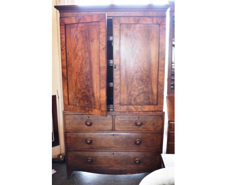 A WILLIAM IV FIGURED MAHOGANY LINEN PRESS  with brass inlaid decoration, the upper section with four sliding trays, the base 
