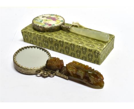 A SMALL WHITE METAL AND CARVED JADE HAND MIRROR  14cm high; together with a painted porcelain hand mirror