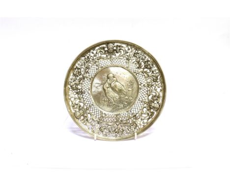 A LATE 19TH CENTURY CONTINENTAL SILVER DECORATIVE ROUND CAKE STAND the centre embossed with a winged putto whispering to a st