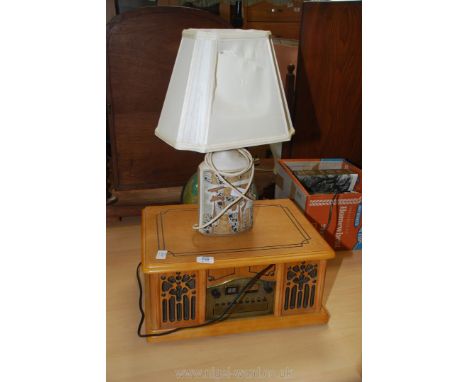 A Hi-fi with integrated speakers and a pottery lamp and shade (a/f.).