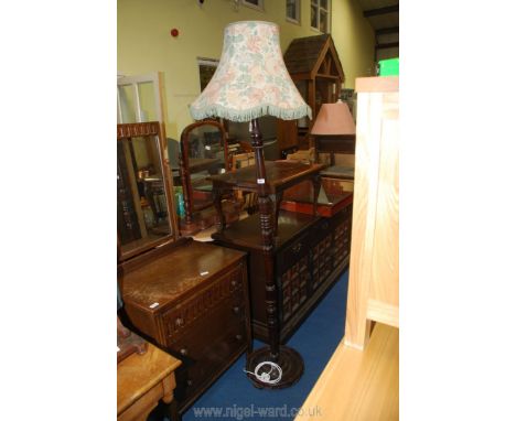 A dark wood standard lamp with shade.