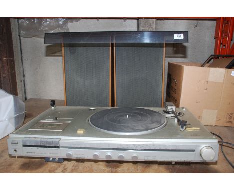 A Hitachi music player with tuner, tape deck and record player with a pair of speakers. 