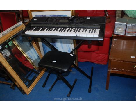 A Casio CTK-5000 electric keyboard and stool.