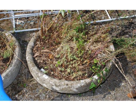 A large circular weathered concrete planter. 27" diameter.