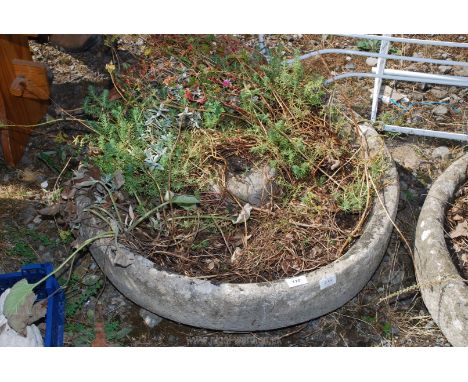A large circular weathered concrete planter. 27" diameter.