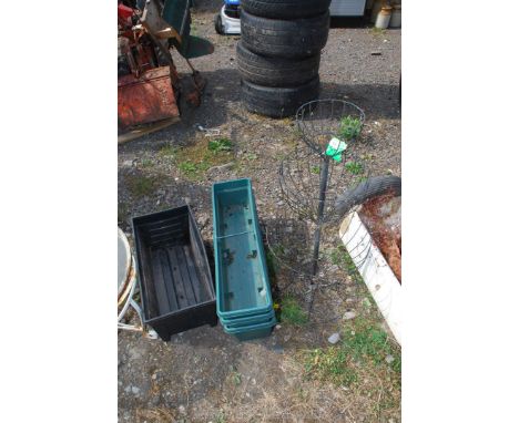 Four plastic window boxes and a metal basket planter.