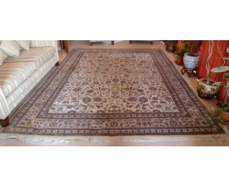 A cream ground Persian carpet with repeating floral pattern and border, 3.7m x 2.8m