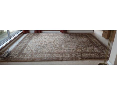 A fawn ground Persian carpet with floral design and repeating motif border, 2.7m x 3.7m