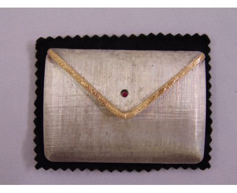 A Halcyon Days silver and 18ct gold compact with a cabochon ruby clasp to hinged cover