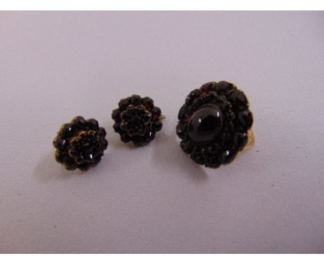 A Victorian garnet and gold ring and a pair of garnet earrings set in gilt metal