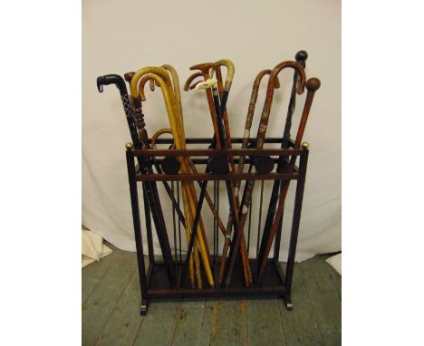 A mahogany umbrella and walking stick stand to include twenty-one walking sticks