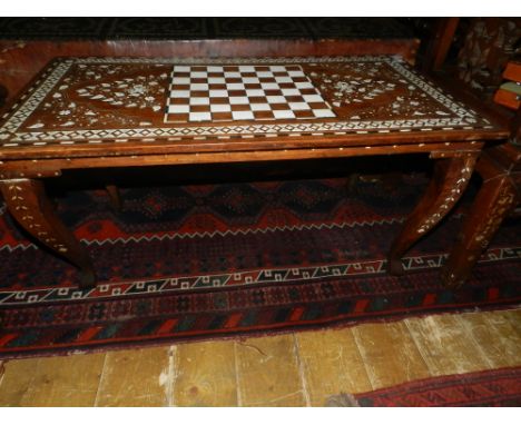 An Indonesian teak chess table, inlaid with bone. H.47cm W.89cm D.47cm