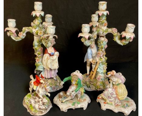 A pair of German four light figural candleabra, encrusted with roses, he with a birds nest, she holding her apron, 36.5cm hig