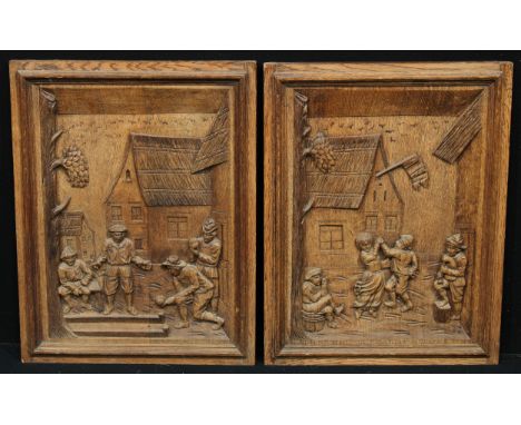 A pair of North European oak panels, carved in relief in the manner of Teniers with tavern dwellers, playing bowls and dancin