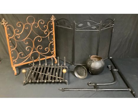 A cast metal fire grate; a wrought iron fire screen; a folding fire screen; a cast iron cook pot with revolving wall mountabl