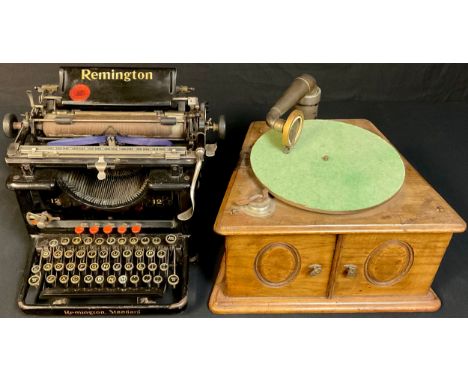 An early 20th century table top wind up gramophone, Academy De Luxe soundbox; an early 20th century Remington No.12 desktop t