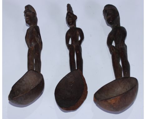 Tribal Art - an Ifugao figural spoon, the haft carved with a stylised bin-nullol figure, 23cm long, Philippines; others (3) 