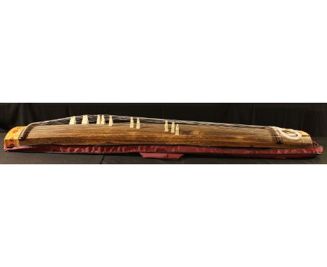 A Chinese guzheng, of typical form, 183cm long, carrying case en suite 