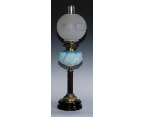 An Art Nouveau brass, hardwood and milk glass oil lamp, the font moulded with sinuous stems, reeded column, stepped circular 