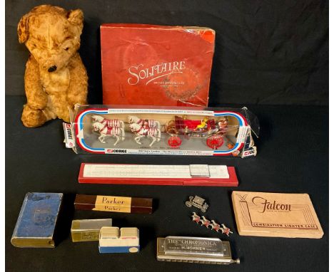 A teddy bear with chime; a Corgi Coronation Coach, Silver Jubilee; a Solitaire set; a miniature coach; a slide rule; a Hohner