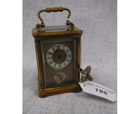 A MINIATURE CARRIAGE CLOCK with an enamel dial and subsidiary alarum dial in a brass case with bevelled glass panels
