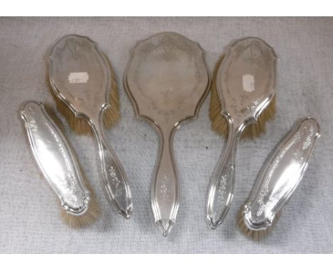 A FOUR PIECE SILVER-BACKED DRESSING TABLE SET comprising mirror, a pair of hair brushes and a pair of clothes brushes by Elki