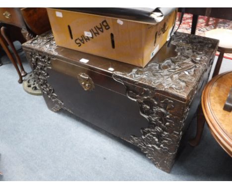 A CAMPHORWOOD TRUNK with carved decoration