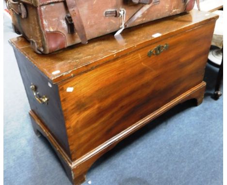 A 19TH CENTURY ELM TRUNK with large brass carrying handles, 38" wide