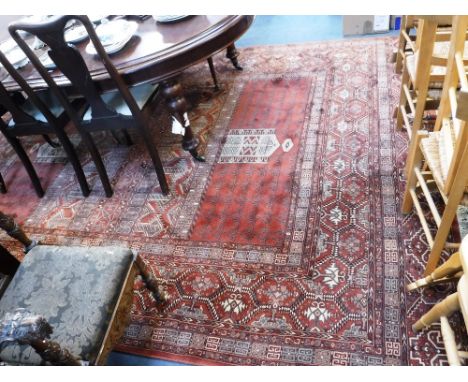 A LARGE RUSSET-RED GROUND PERSIAN DESIGN CARPET, 89'' X 136''