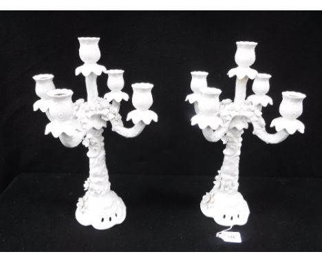 A PAIR OF WHITE GLAZED CERAMIC FIVE BRANCH CANDELABRA of naturalistic form
