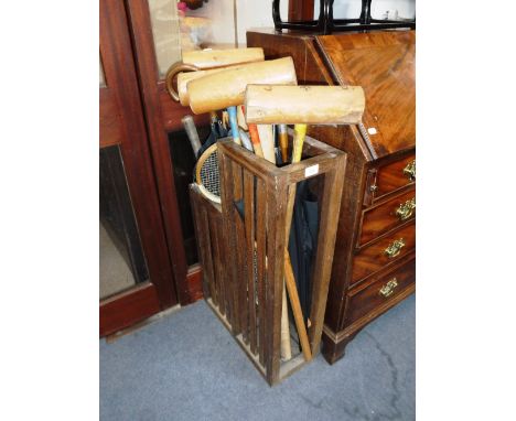 AN ARTS & CRAFTS OAK STICK-STAND and the contents including croquet mallets and umbrellas 